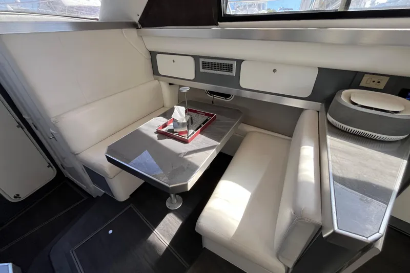 Slide: The Image of Interior of 1995 Cruisers Yachts 3650 Motoryacht with white seating and table. - 29