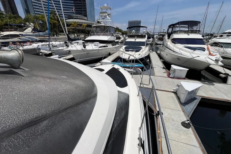 Slide: The Image of 1995 Cruisers Yachts 3650 Motoryacht docked among other luxury boats in a marina. - 3