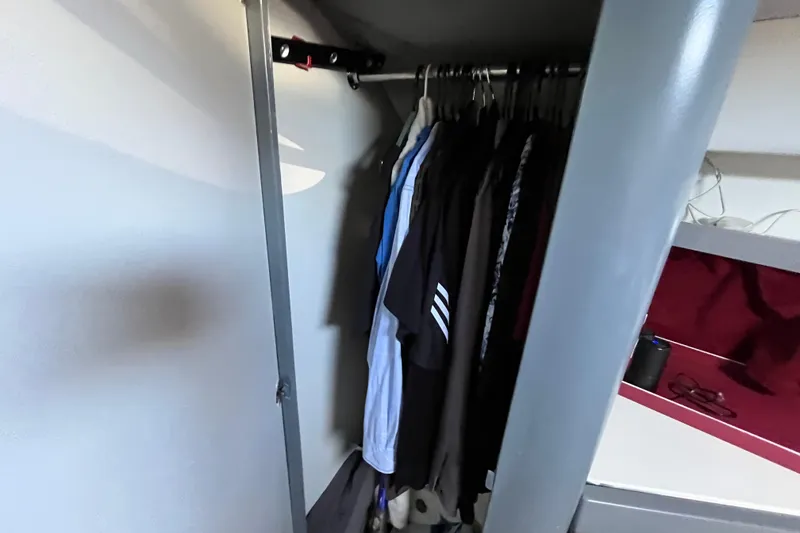 Slide: The Image of Closet interior of 1995 Cruisers Yachts 3650 Motoryacht with hanging clothes. - 36