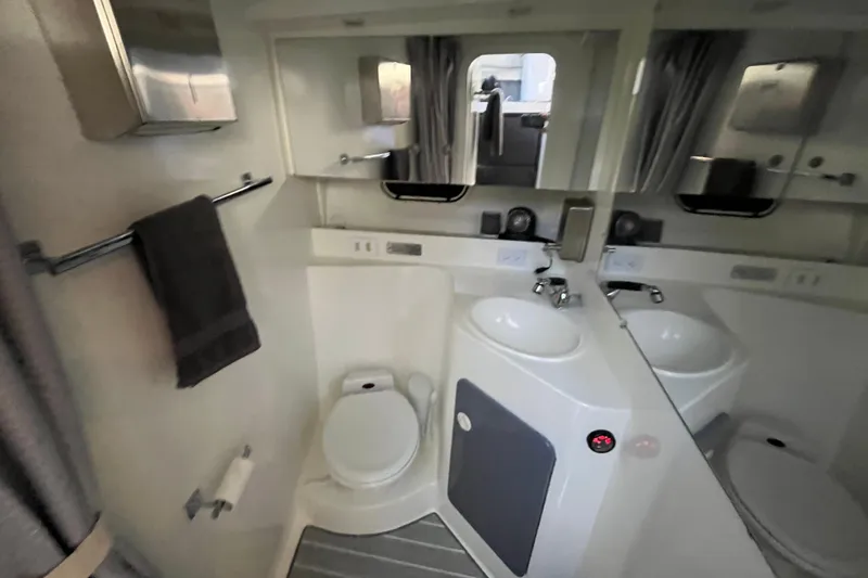 Slide: The Image of Bathroom interior of 1995 Cruisers Yachts 3650 Motoryacht with sink, toilet, and mirror. - 38