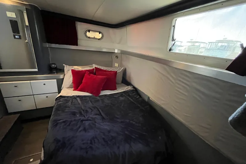 Slide: The Image of Cozy bedroom interior of 1995 Cruisers Yachts 3650 Motoryacht with bed and window view. - 40