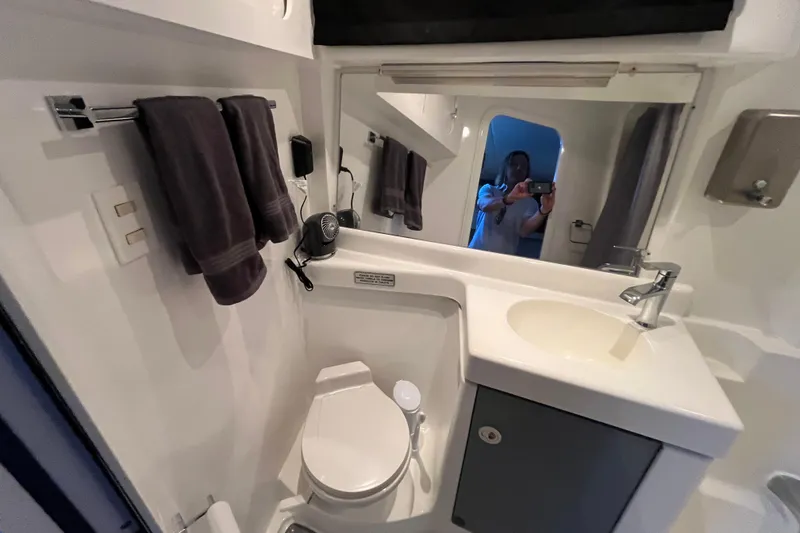 Slide: The Image of Bathroom interior of 1995 Cruisers Yachts 3650 Motoryacht, featuring sink, toilet, and mirror. - 43