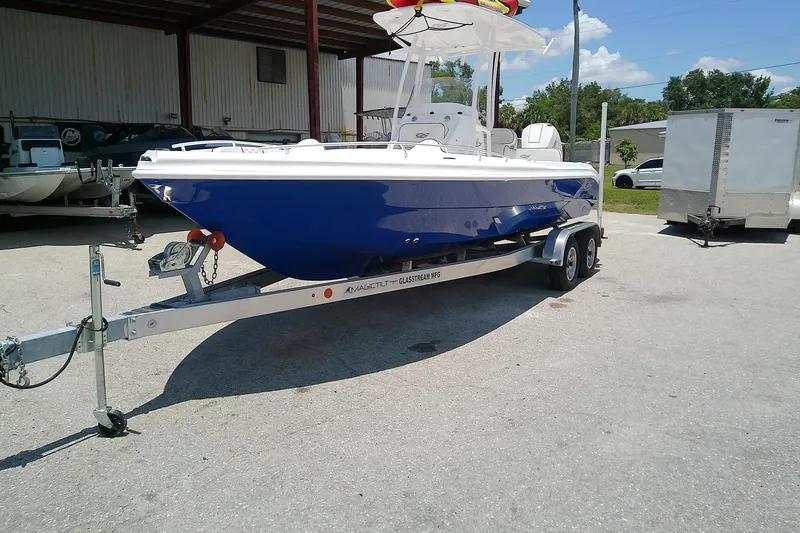 The Image of 2025 Glasstream 240 CCX boat on trailer, parked outdoors under a canopy. - 0
