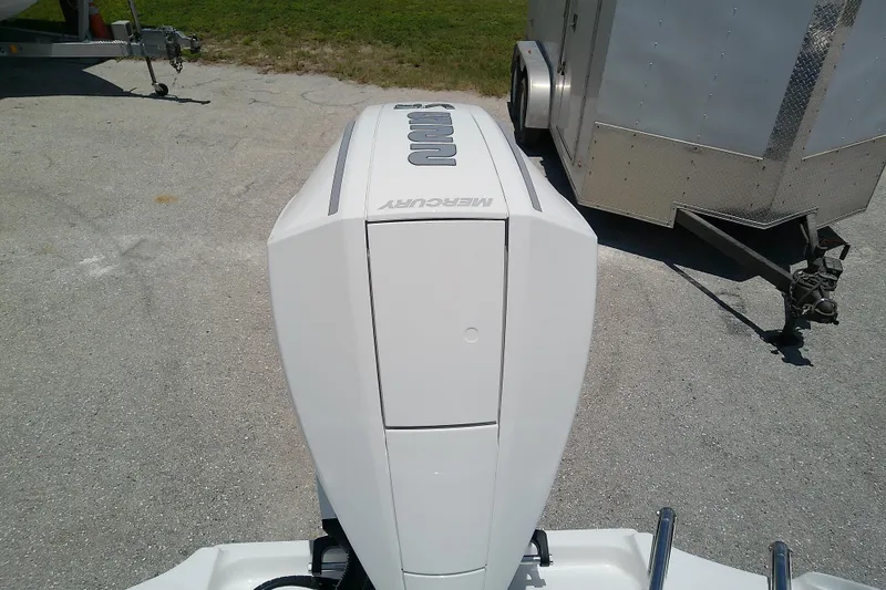 Slide: The Image of 2025 Glasstream 240 CCX boat with Mercury outboard engine, parked near a trailer. - 11