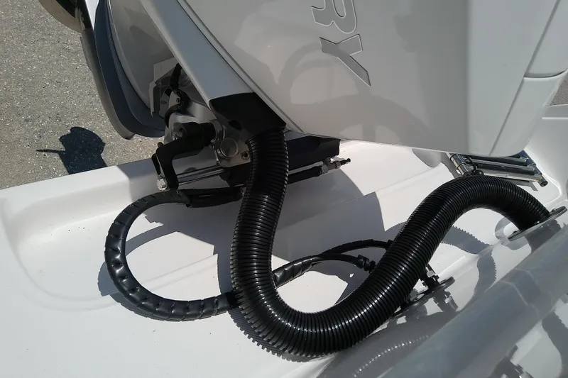 Slide: The Image of 2025 Glasstream 240 CCX boat engine detail with cables and tubing. - 12