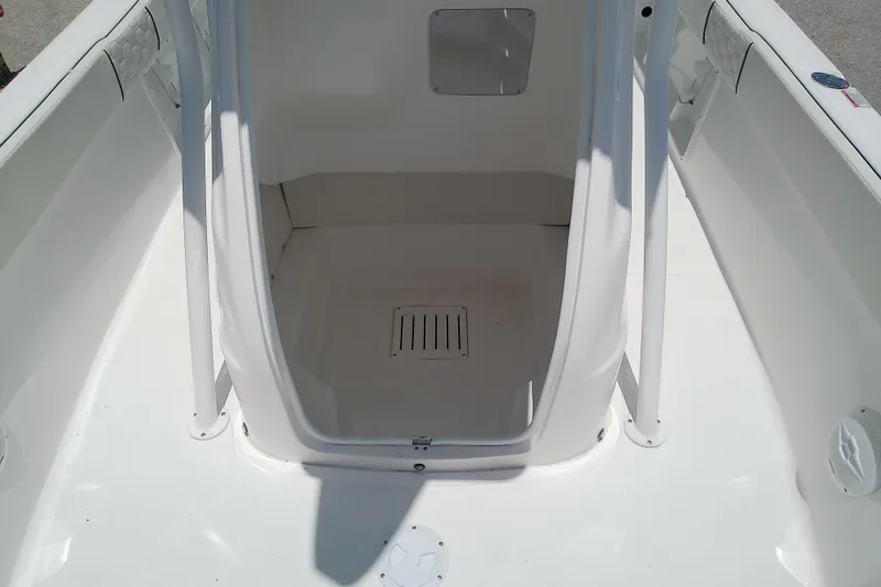 Slide: The Image of 2025 Glasstream 240 CCX boat interior with white finish and storage compartment. - 16