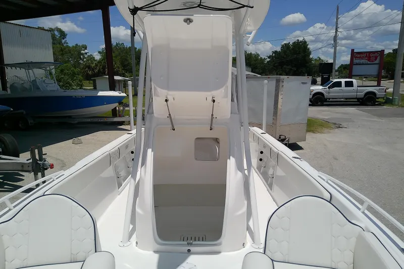 Slide: The Image of 2025 Glasstream 240 CCX boat interior with open storage compartment, parked outdoors. - 17