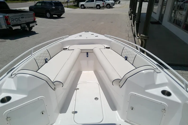 Slide: The Image of 2025 Glasstream 240 CCX boat interior with white cushioned seating and storage compartments. - 29