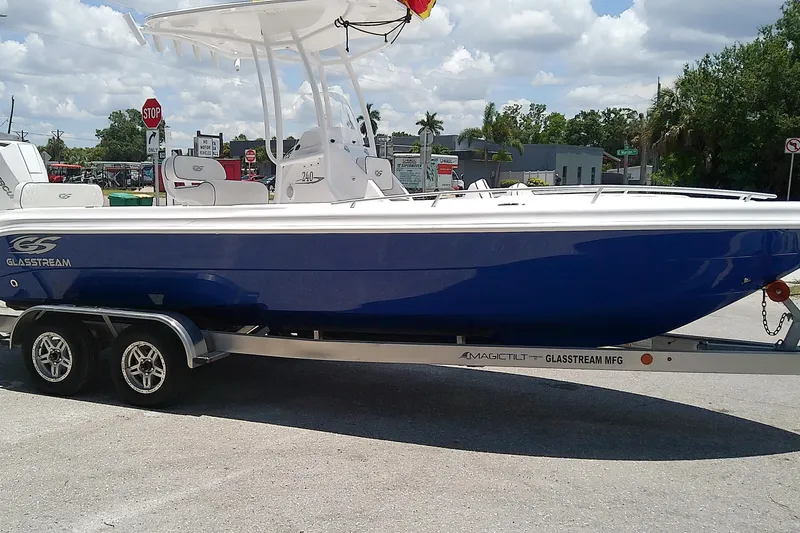 Slide: The Image of 2025 Glasstream 240 CCX boat on trailer, blue hull, parked outdoors. - 3