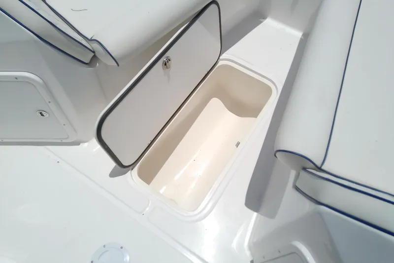 Slide: The Image of 2025 Glasstream 240 CCX boat interior storage compartment with cushioned seating. - 31