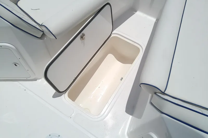 Slide: The Image of 2025 Glasstream 240 CCX boat storage compartment with open hatch, showcasing interior space. - 32