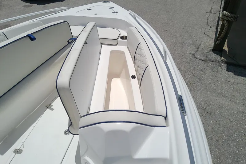 Slide: The Image of 2025 Glasstream 240 CCX boat interior with white seating and storage compartment. - 33