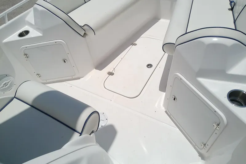 Slide: The Image of Interior view of 2025 Glasstream 240 CCX boat, featuring white seating and storage compartments. - 35