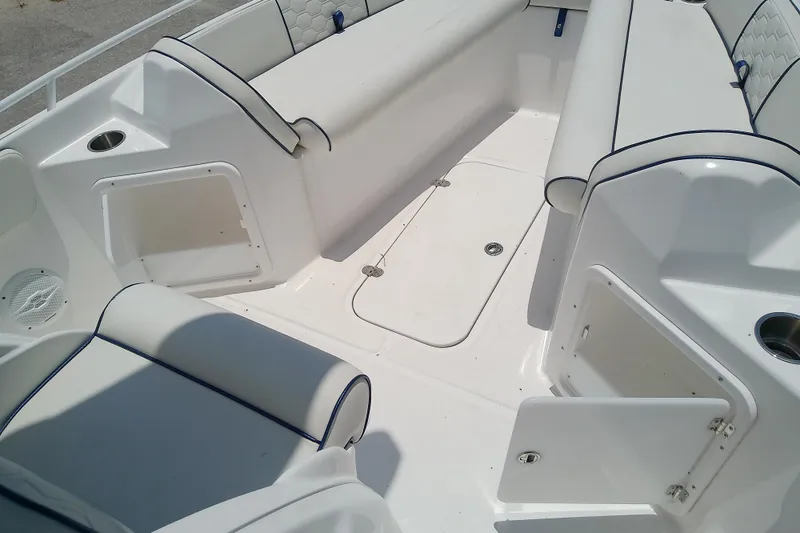 Slide: The Image of 2025 Glasstream 240 CCX boat interior with white seating and storage compartments. - 36