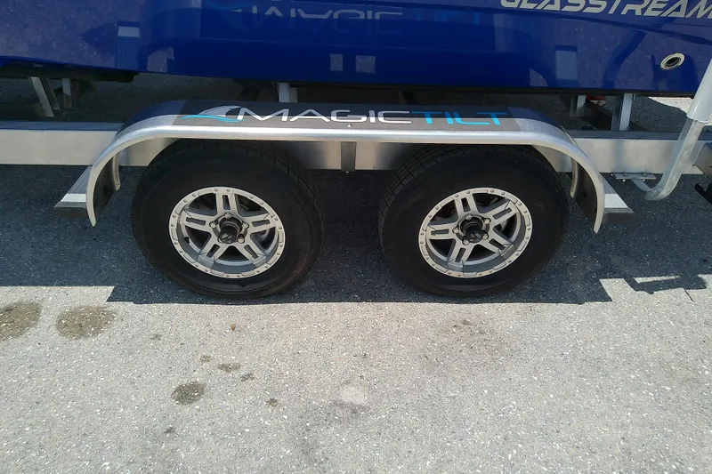 Slide: The Image of Trailer wheels of a 2025 Glasstream 240 CCX boat on Magic Tilt trailer. - 41