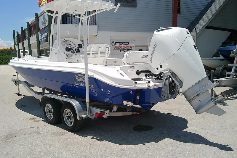 Slide: The Image of 2025 Glasstream 240 CCX boat with Mercury engine on a trailer, parked outdoors. - 5