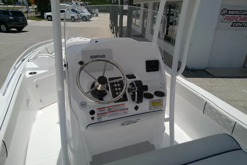 Slide: The Image of 2025 Glasstream 240 CCX boat console with steering wheel and controls. - 6