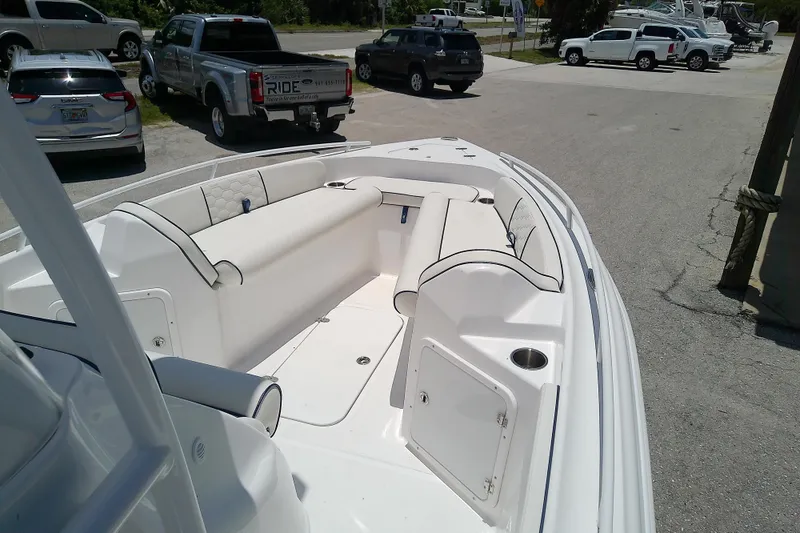 Slide: The Image of 2025 Glasstream 240 CCX boat interior with white seating and storage compartments. - 8