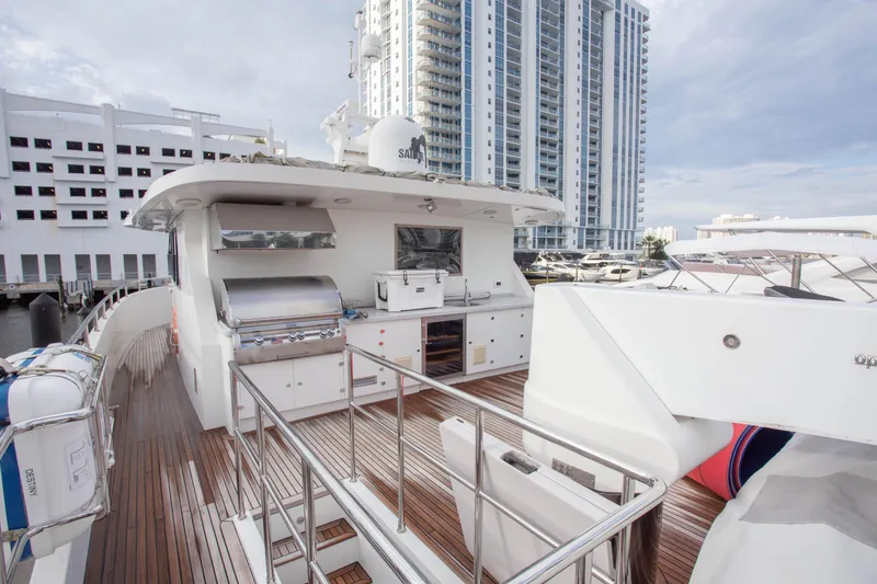 Slide: The Image of Luxurious 2014 Fifth Ocean Yachts 24m Explorer Yacht with outdoor kitchen and cityscape backdrop. - 10