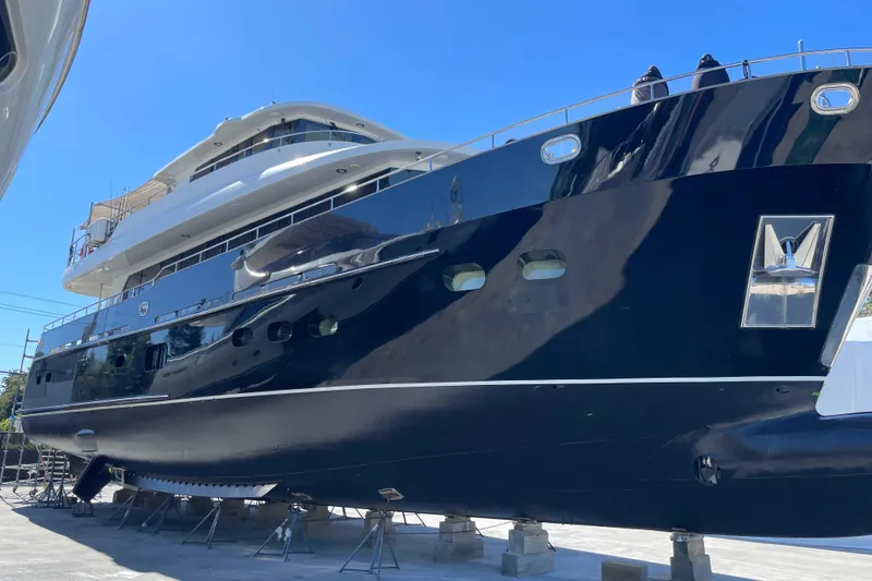 Slide: The Image of 2014 Fifth Ocean Yachts 24m Displacement Explorer Yacht on dry dock, showcasing sleek design. - 3