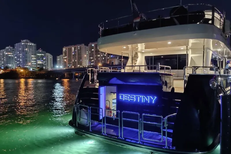 Slide: The Image of Luxurious Fifth Ocean Yachts 24m Explorer Yacht at night, city skyline in background. - 4