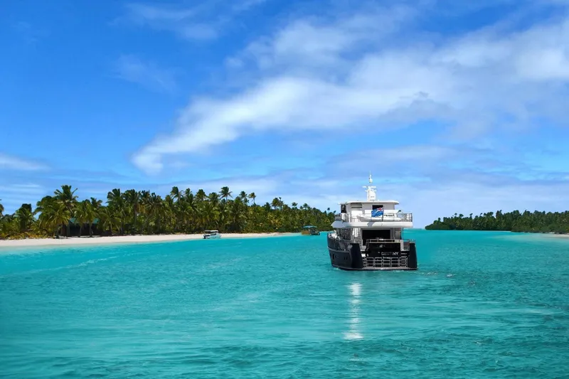 Slide: The Image of Fifth Ocean Yachts 24m Explorer Yacht cruising in turquoise waters near a tropical island, 2014. - 91