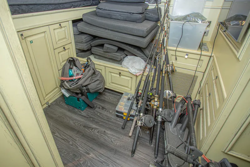 Slide: The Image of Storage area on 2014 Fifth Ocean Yachts Explorer, featuring fishing rods and equipment. - 71
