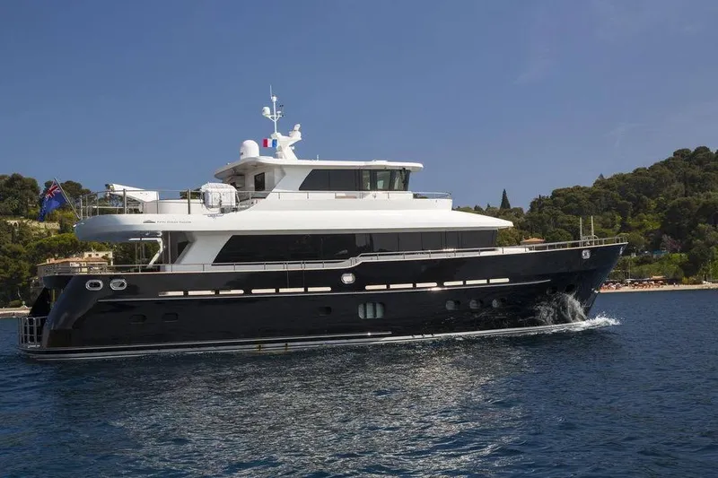 Slide: The Image of Fifth Ocean Yachts 24m Displacement Explorer Yacht, 2014, cruising near a scenic coastline. - 98