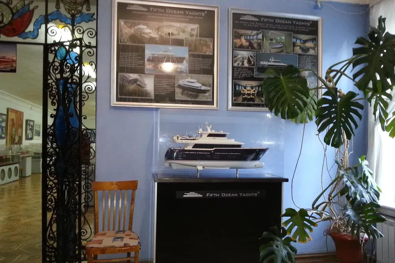 Slide: The Image of Model of Fifth Ocean Yachts 24m Displacement Explorer Yacht, 2014, displayed indoors with informational posters. - 102