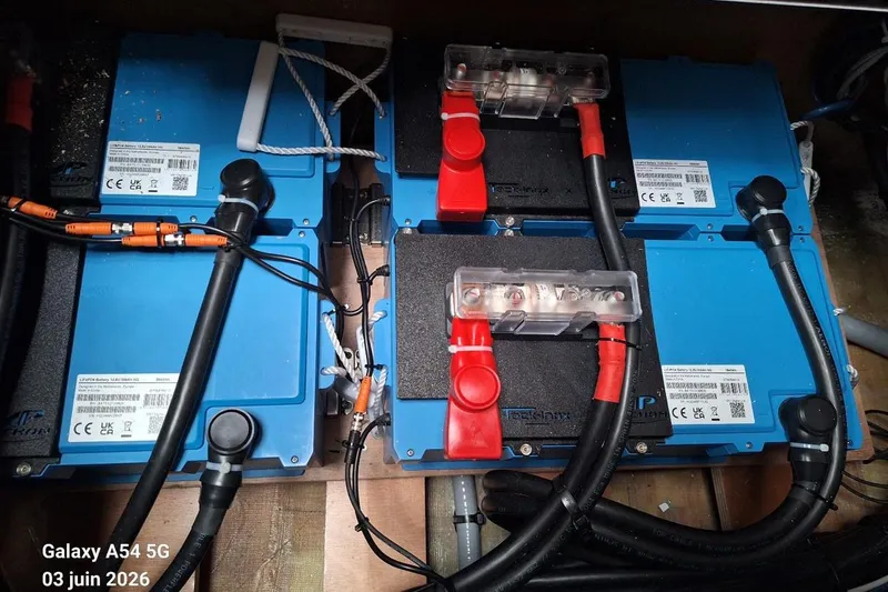 Slide: The Image of Electrical setup with batteries and controllers in a 2026 Excess 14 model. - 28