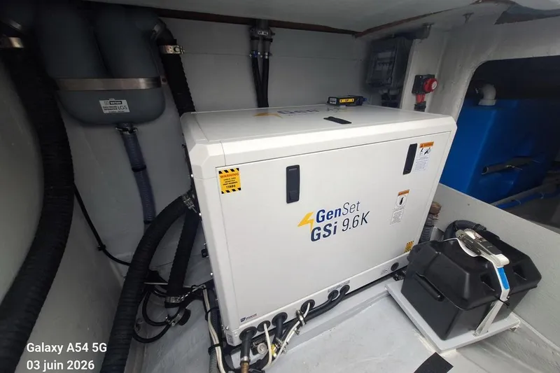 Slide: The Image of Engine compartment of 2026 Excess 14 with GenSet GSi 9.6K generator and battery. - 34