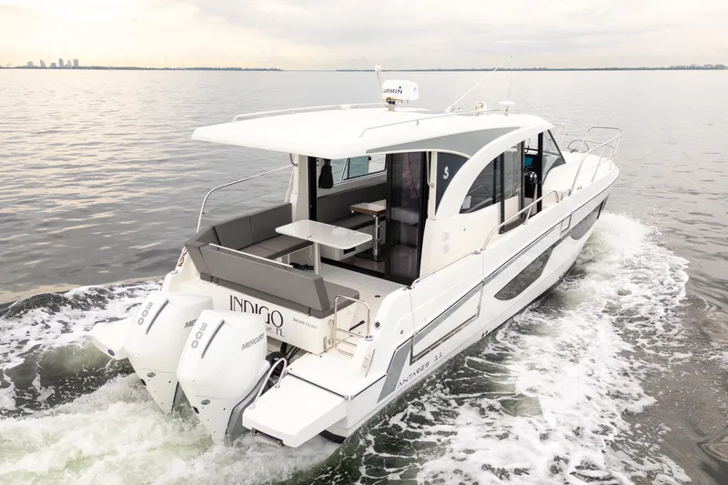Slide: The Image of 2023 Beneteau Antares 11 cruising on calm waters, showcasing sleek design and powerful engines. - 11