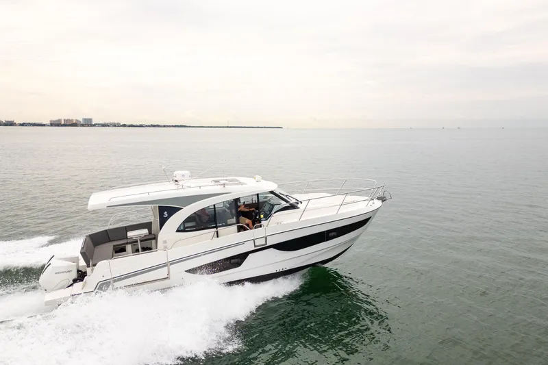 Slide: The Image of 2023 Beneteau Antares 11 cruising on open water, showcasing sleek design and performance. - 12