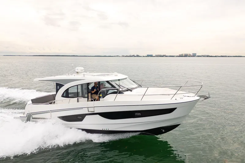 Slide: The Image of 2023 Beneteau Antares 11 cruising on open water, showcasing sleek design and performance. - 13