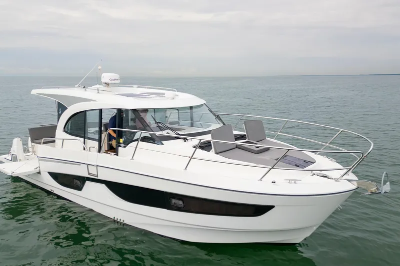 Slide: The Image of 2023 Beneteau Antares 11 boat on calm water, showcasing sleek design and modern features. - 19