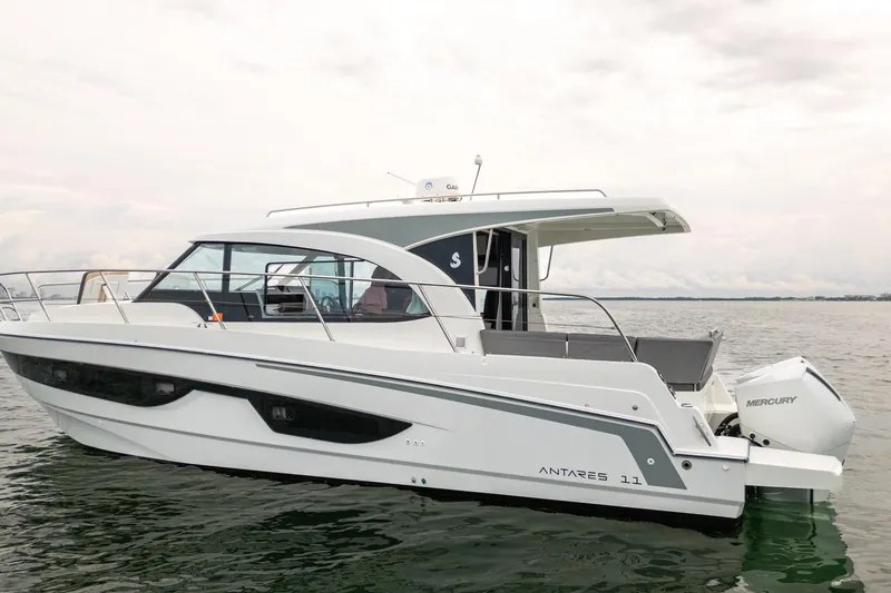 Slide: The Image of 2023 Beneteau Antares 11 boat on calm water, featuring sleek design and Mercury outboard engine. - 21
