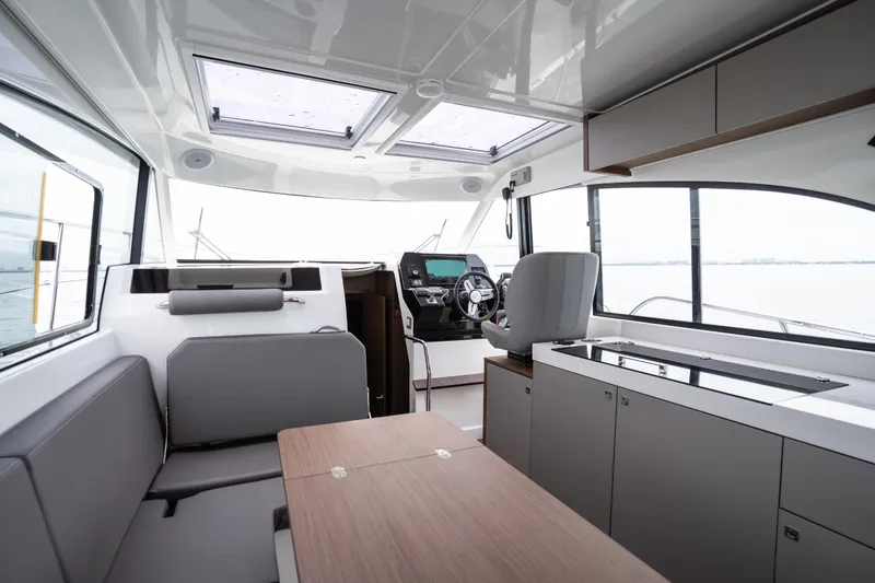 Slide: The Image of Interior of 2023 Beneteau Antares 11 yacht, featuring modern helm and seating area. - 22
