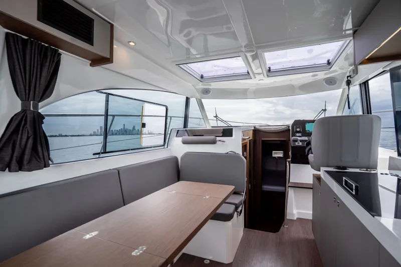 Slide: The Image of Interior of 2023 Beneteau Antares 11 yacht with modern seating and panoramic windows. - 23