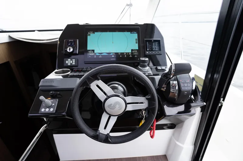 Slide: The Image of Cockpit of 2023 Beneteau Antares 11 with advanced navigation controls and steering wheel. - 24