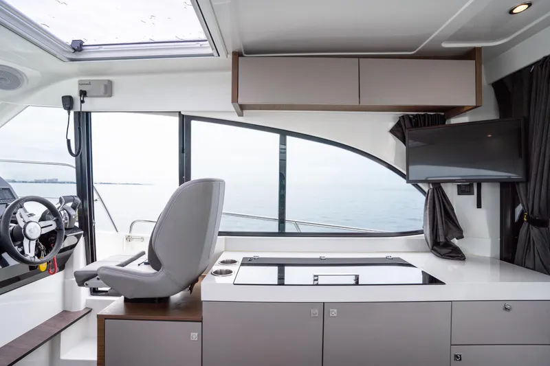 Slide: The Image of Interior of 2023 Beneteau Antares 11, featuring helm, seating, and modern amenities. - 26