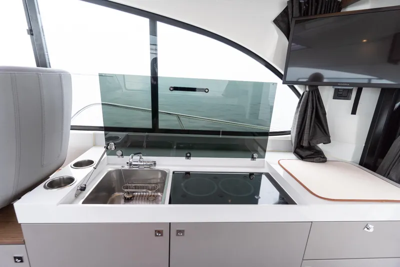 Slide: The Image of Modern kitchen area in 2023 Beneteau Antares 11 yacht with sink and stove. - 27