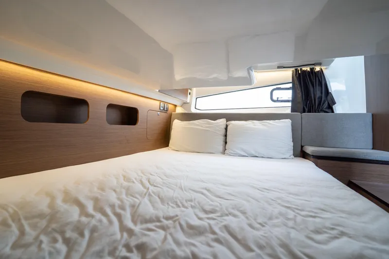 Slide: The Image of Luxurious cabin interior of 2023 Beneteau Antares 11 with cozy bedding and modern design. - 32