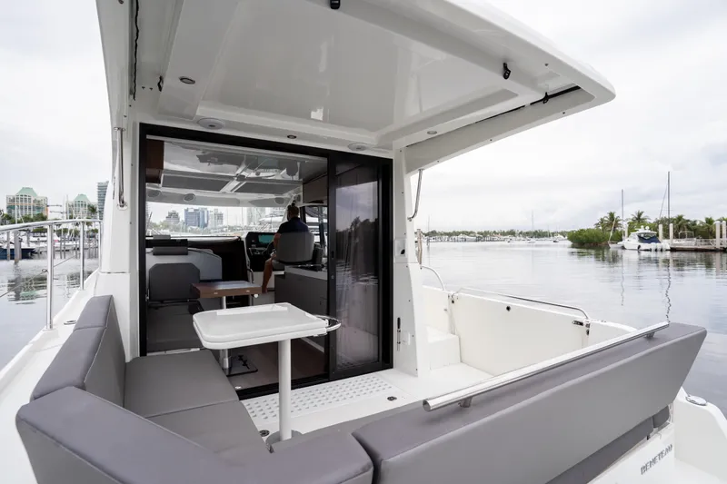Slide: The Image of 2023 Beneteau Antares 11 yacht interior with seating and table, docked at marina. - 41