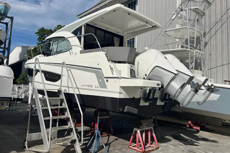 Slide: The Image of 2023 Beneteau Antares 11 boat on dry dock with twin outboard engines. - 48