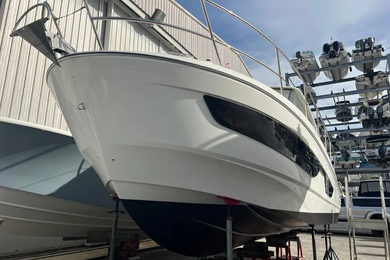Slide: The Image of 2023 Beneteau Antares 11 boat in dry dock, showcasing sleek design and modern features. - 49