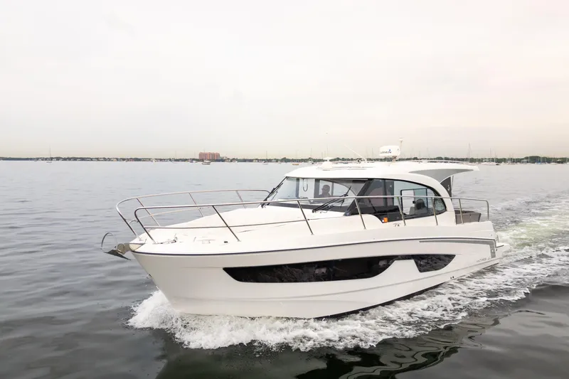 Slide: The Image of 2023 Beneteau Antares 11 cruising on calm waters, showcasing sleek design and modern features. - 9