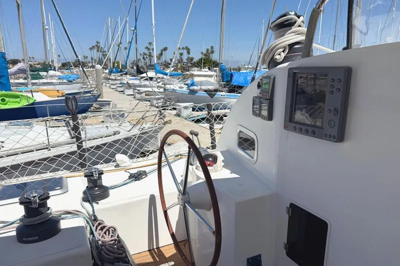 Slide: The Image of Steering area of a 2004 Outremer Standard sailboat docked at a marina. - 1