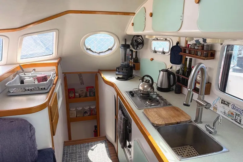 Slide: The Image of 2004 Outremer Standard yacht kitchen with modern appliances and ample storage. - 10