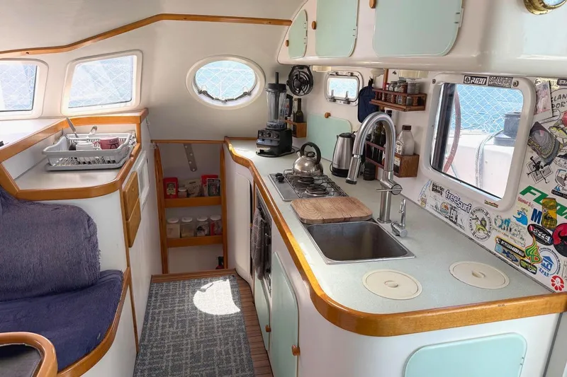 Slide: The Image of Interior of 2004 Outremer Standard yacht kitchen with modern amenities and cozy seating. - 12