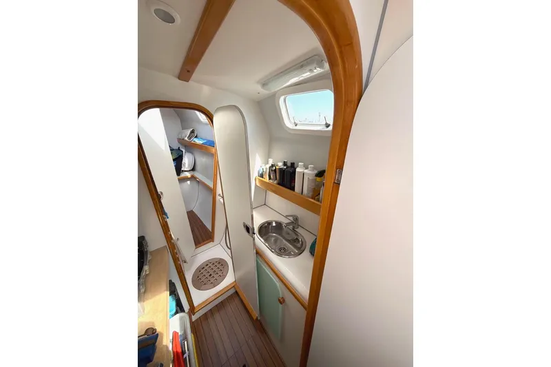 Slide: The Image of Interior of 2004 Outremer Standard yacht bathroom with sink, shower, and storage shelves. - 16